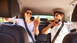 Two friends on the backseat of the car