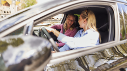 Mother and daughter head out on a trip by car.
