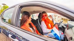 Friends in car, wearing Kingsday outfit